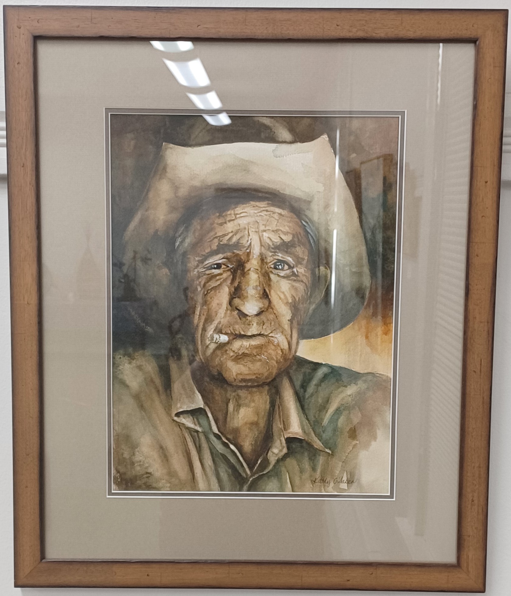 Older man with cowboy hat and cigarette