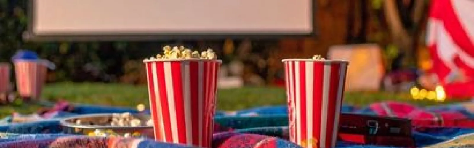 2 popcorn buckets and outdoor movie screen