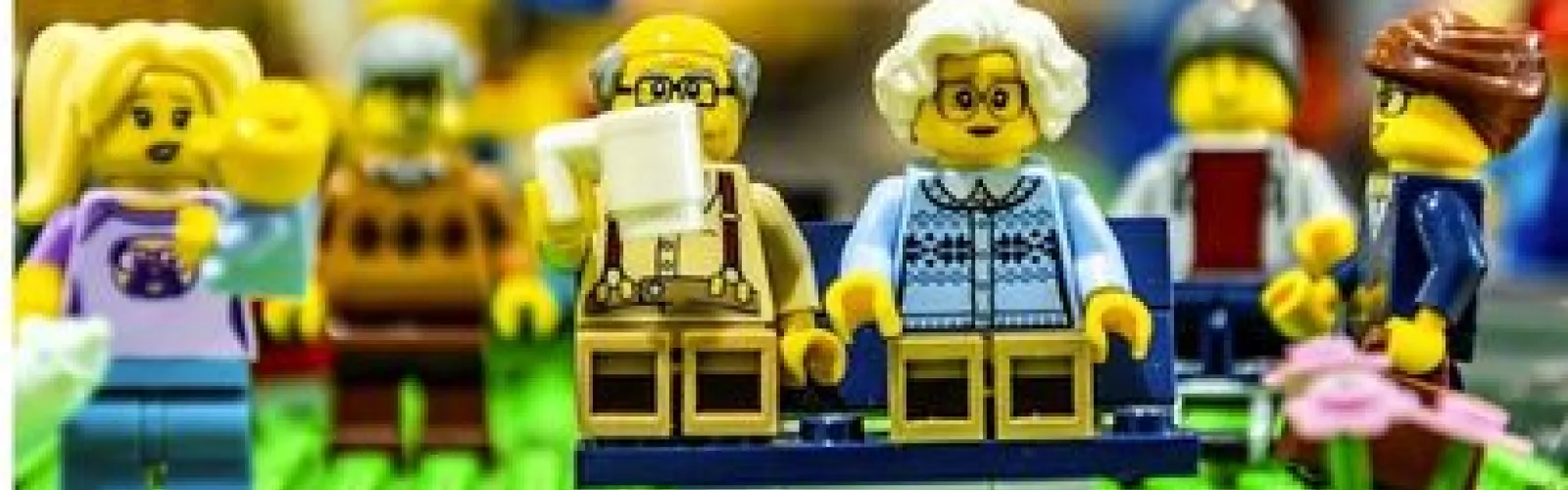 A family of Lego minifigures with adults and older legos